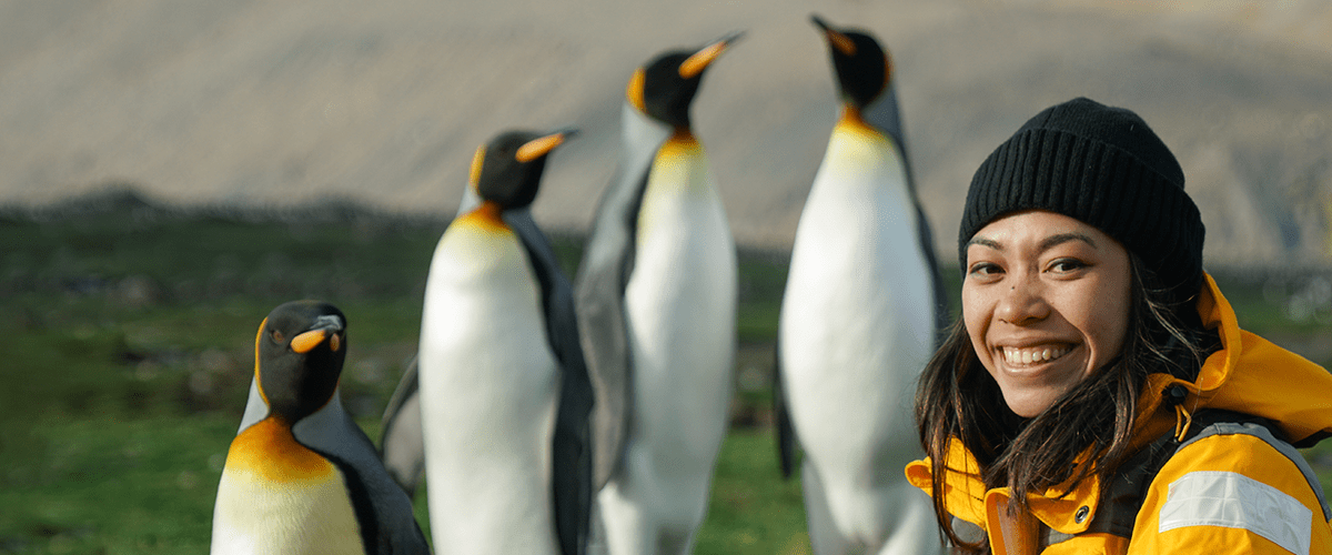 Research student with penguins